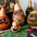 This shows several monster gourds carved with silly faces. They are waiting for me to make their custom hats.